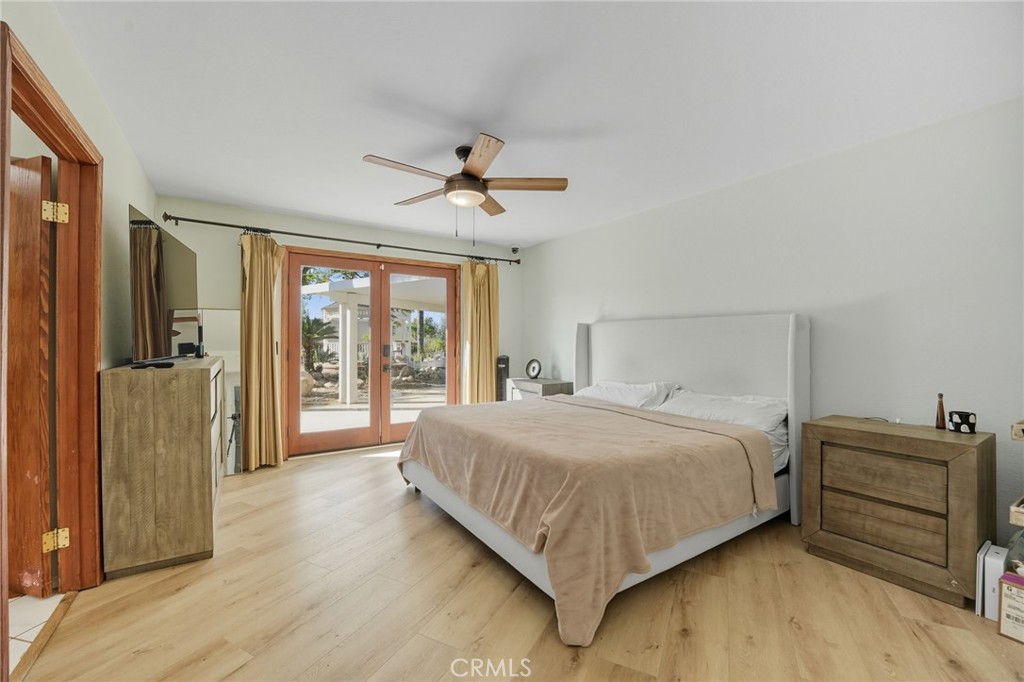 15901 Viewpoint Road Riverside, CA 92504 - Photo 29 of 46 a bedroom with a large bed and a chandelier