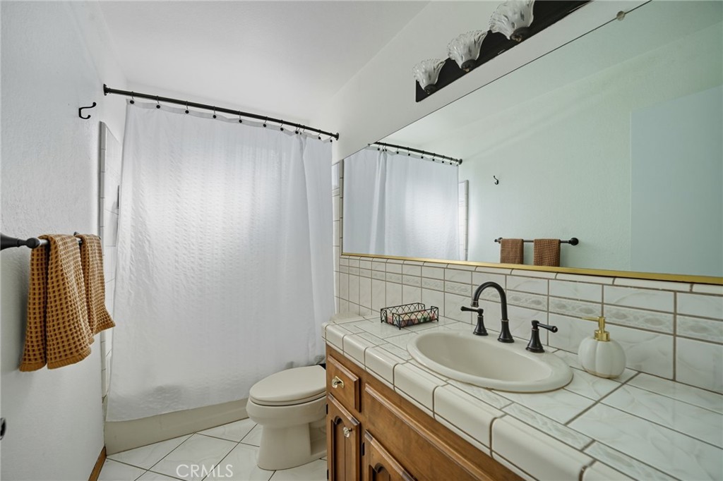 15901 Viewpoint Road Riverside, CA 92504 - Photo 36 of 46 a bathroom with a sink toilet and shower