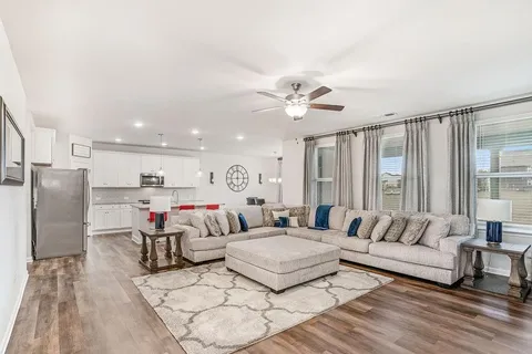 a living room with furniture and a large window