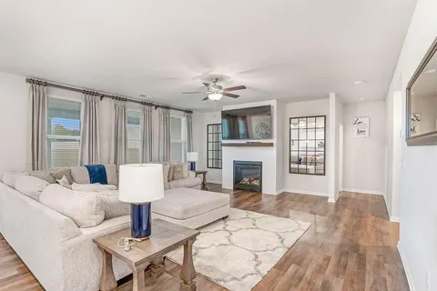 a living room with furniture and a fireplace