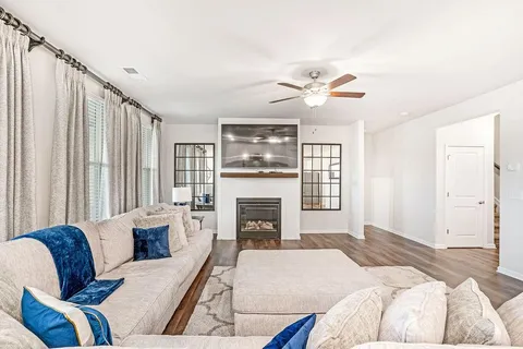 a bedroom with furniture fireplace and a window