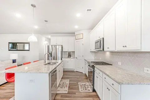 a kitchen with a sink stove and cabinets