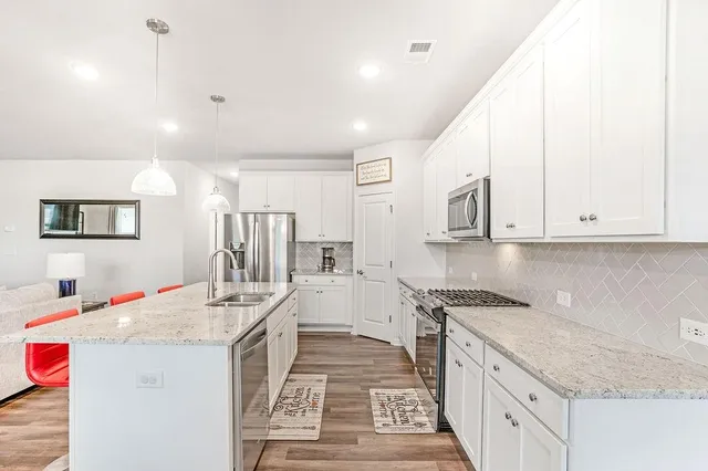 a kitchen with a sink stove and cabinets