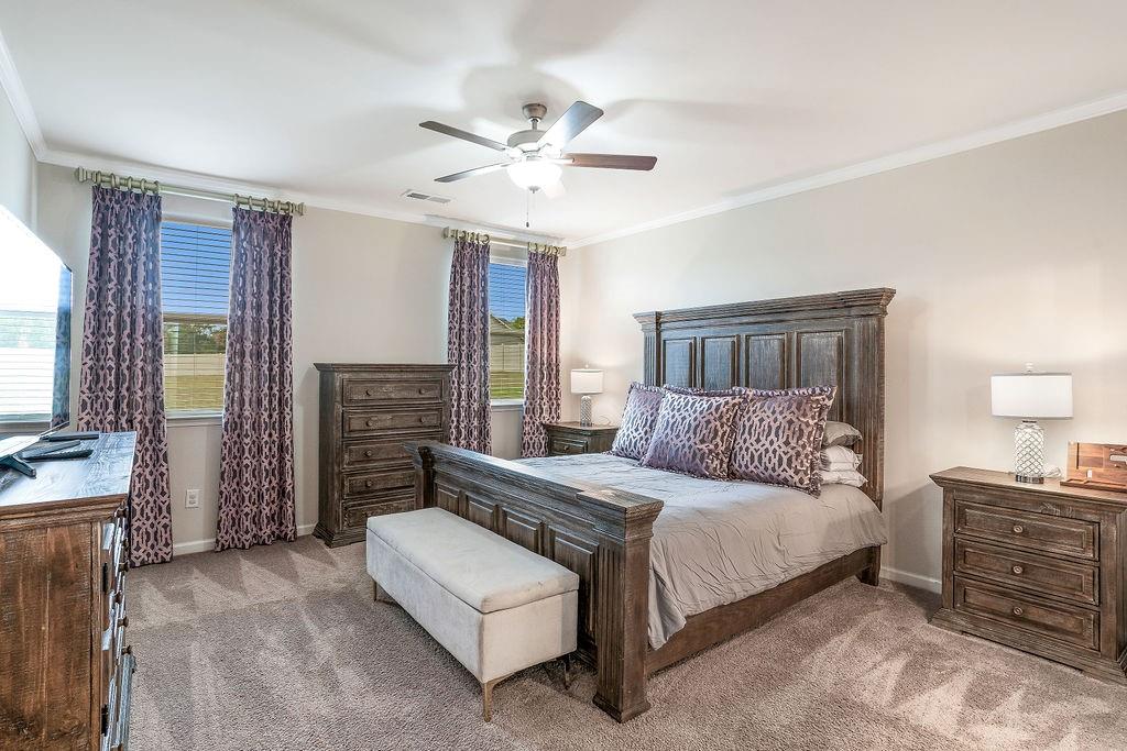 112 Leveret Road Locust Grove, GA 30248 - Photo 20 of 47 a bedroom with a bed dresser and a flat screen tv