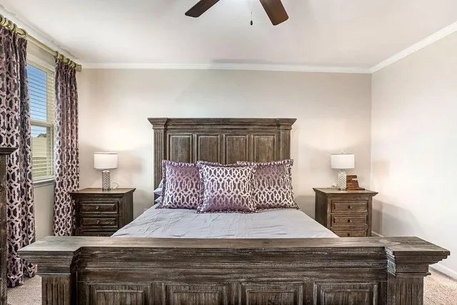 a bedroom with a bed and a lamp on dresser