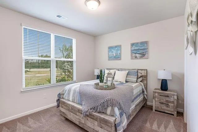 a bedroom with bed and a window