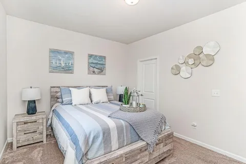 a bedroom with a large bed and a table