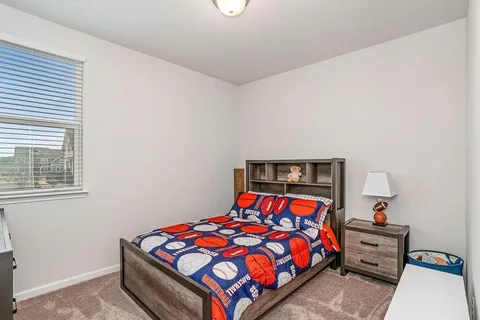 a bedroom with a bed and window