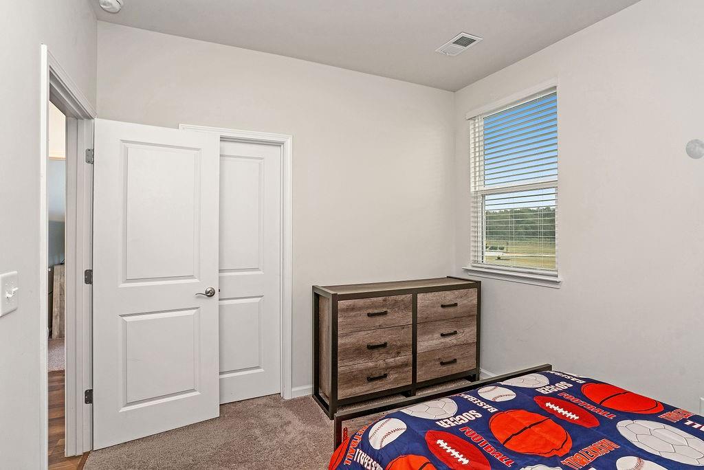 112 Leveret Road Locust Grove, GA 30248 - Photo 32 of 47 a view of an empty room with window and dresser