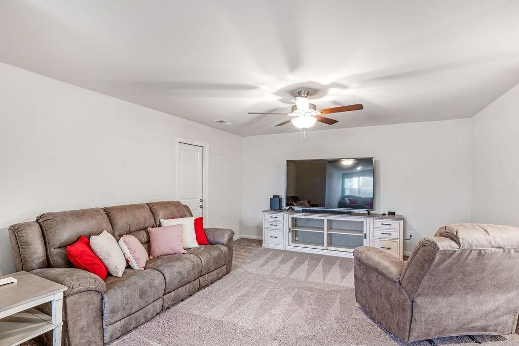 112 Leveret Road Locust Grove, GA 30248 - Photo 35 of 47 a living room with furniture and a flat screen tv