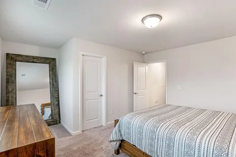 a bedroom with a bed and a table