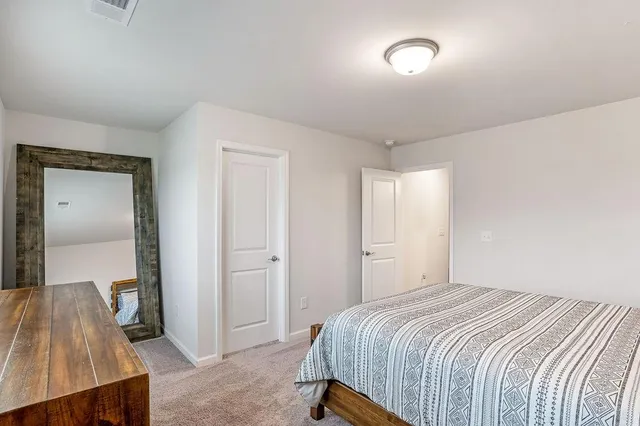 a bedroom with a bed and a table