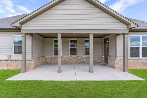 a view of an house with backyard porch and furniture