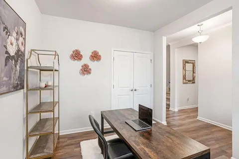 a view of a workspace with furniture and wooden floor