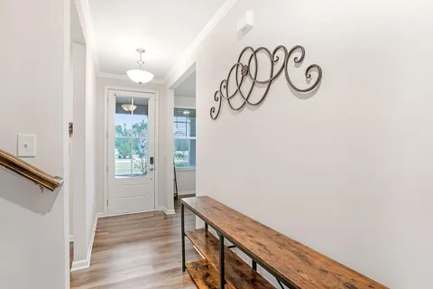 a view of an entryway with wooden floor