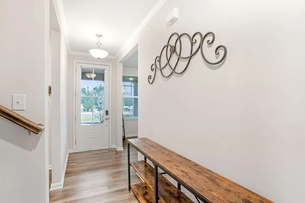 a view of an entryway with wooden floor