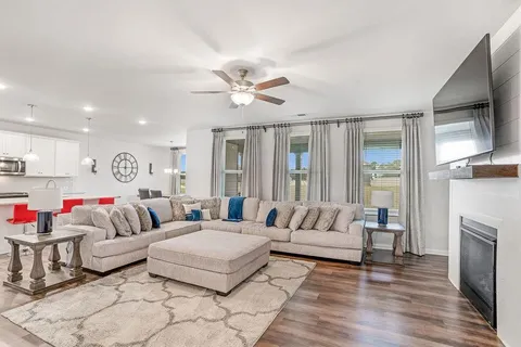 a living room with furniture fireplace and flat screen tv