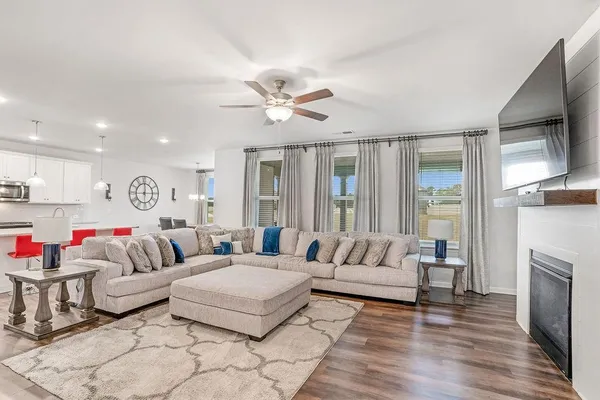 a living room with furniture fireplace and flat screen tv