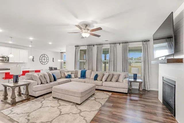 a living room with furniture fireplace and flat screen tv