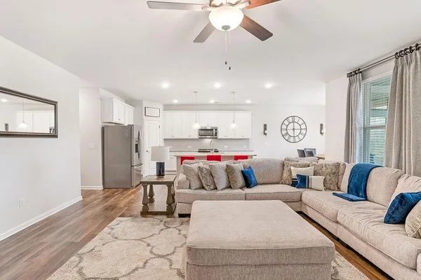 a living room with furniture and kitchen view