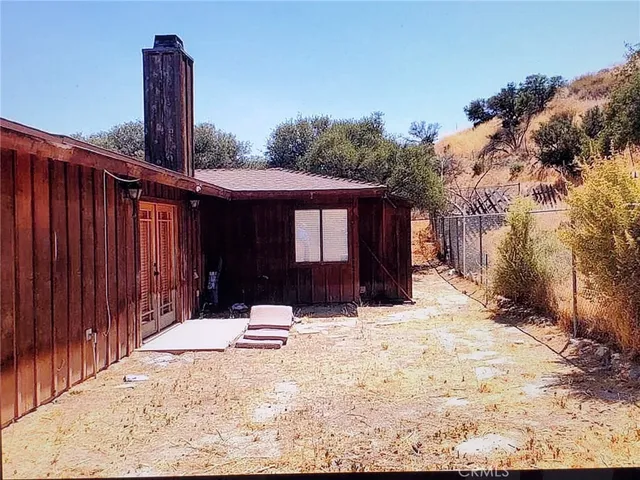a wooden bench sitting in front of a house