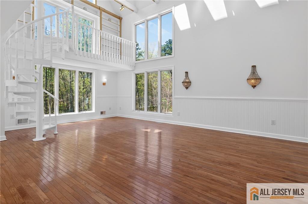 381 Monmouth Road Freehold, NJ 07728 - Photo 37 of 63 a view of an empty room with wooden floor and a window