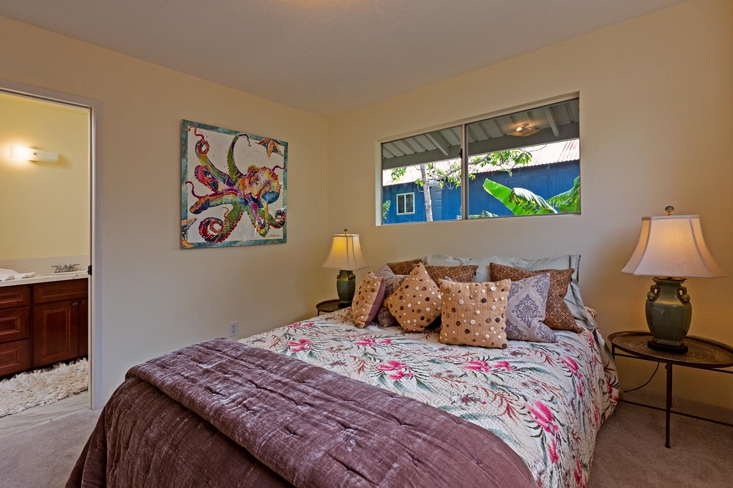 974 Haiku Road Haiku, HI 96708 - Photo 12 of 27 a bedroom with a bed and a painting on the wall
