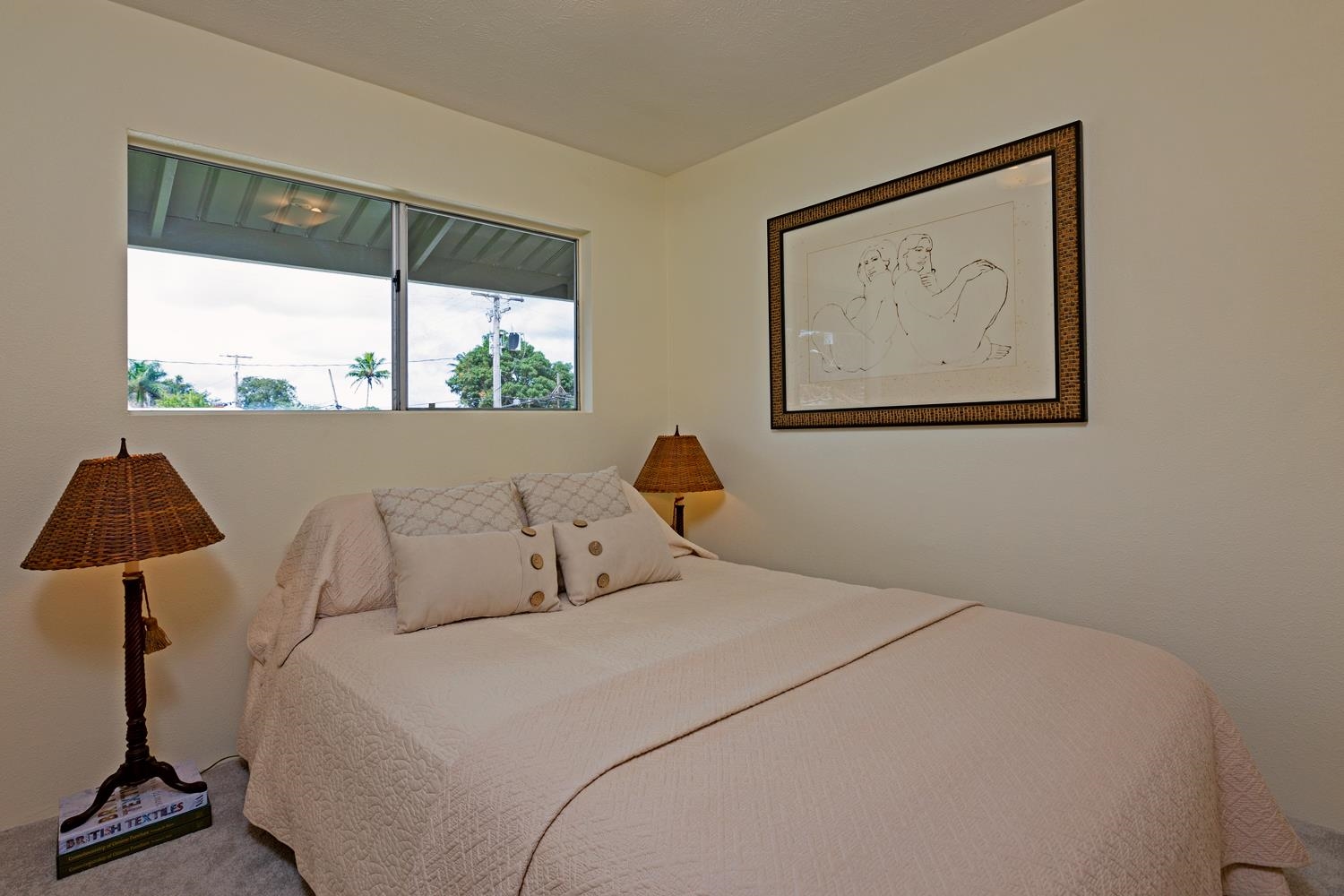 974 Haiku Road Haiku, HI 96708 - Photo 16 of 27 a bedroom with a bed and a painting on the wall