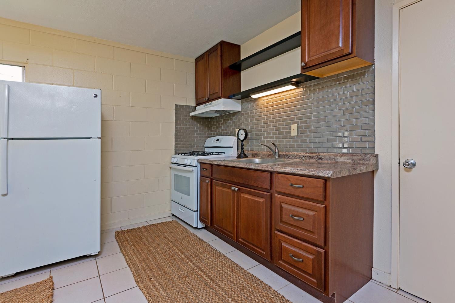 974 Haiku Road Haiku, HI 96708 - Photo 18 of 27 a kitchen with stainless steel appliances granite countertop a sink stove and refrigerator