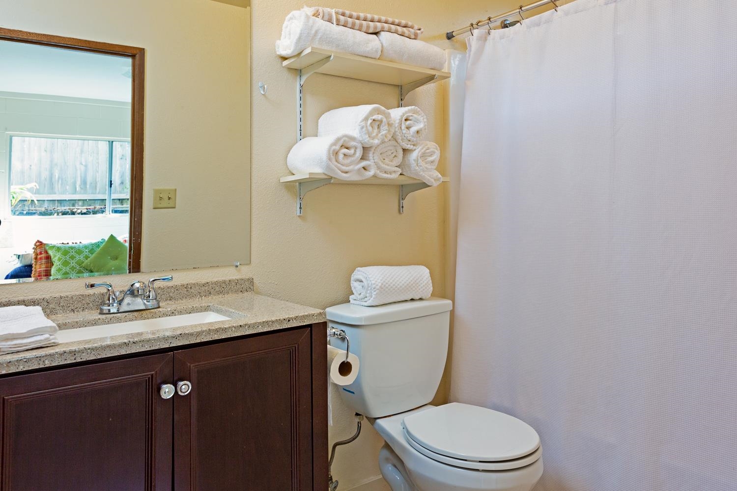 974 Haiku Road Haiku, HI 96708 - Photo 20 of 27 a bathroom with a granite countertop toilet sink and mirror