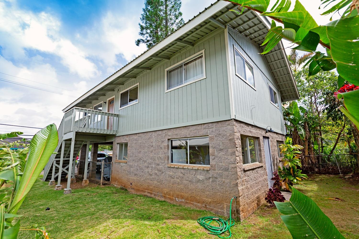 974 Haiku Road Haiku, HI 96708 - Photo 24 of 27 a view of a house with many windows and plants