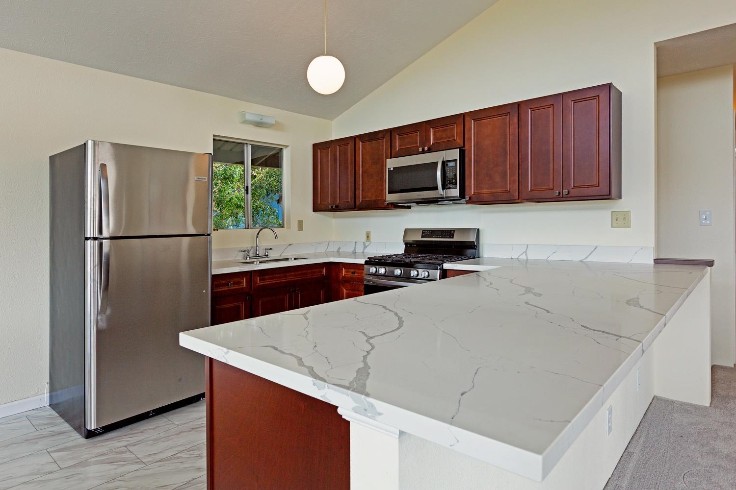 974 Haiku Road Haiku, HI 96708 - Photo 4 of 27 a kitchen with stainless steel appliances a refrigerator sink and microwave