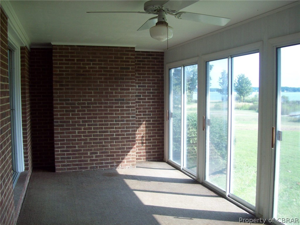 344 Ballast Point Road Hudgins, VA 23076 - Photo 7 of 12 a view of a balcony with a ceiling fan and a window