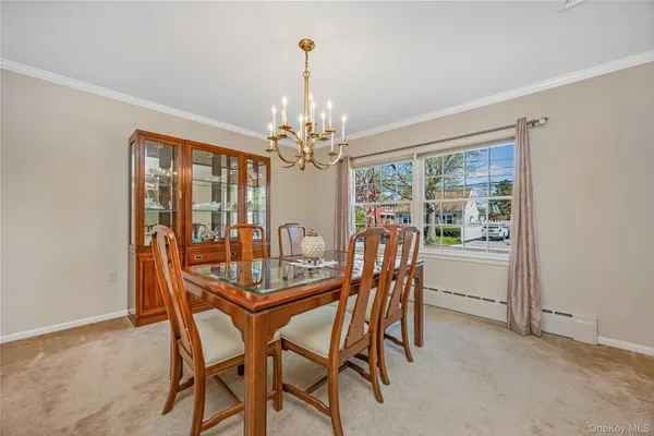 a dining room with furniture a chandelier and window
