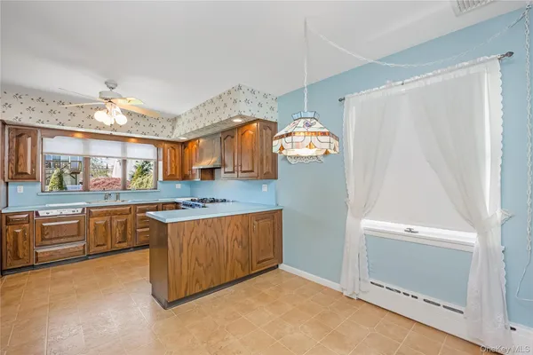 a kitchen with granite countertop a stove and a sink