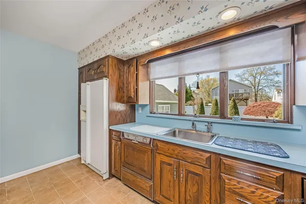 a bathroom with a sink and large window