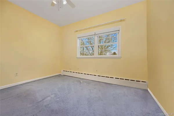 an empty room with a empty space and a ceiling fan