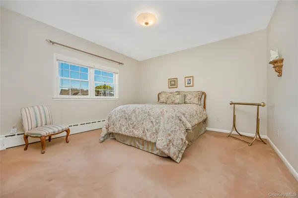 a bedroom with a bed chair and window