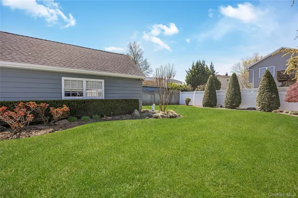 a view of a house with garden and a yard