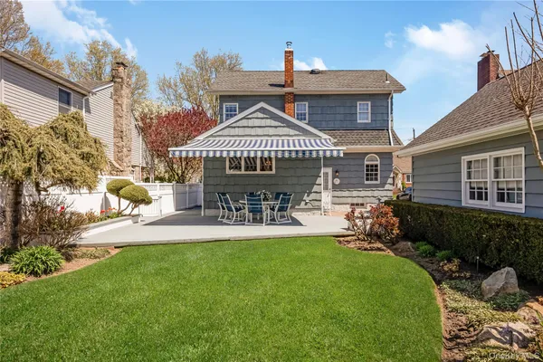 a view of a house with a big yard and potted plants