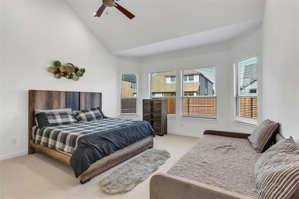 1241 Lupine Road Prosper, TX 75078 - Photo 19 of 38 Spacious room featuring a vaulted ceiling with a ceiling fan, bay windows, white walls, and light-colored carpeting