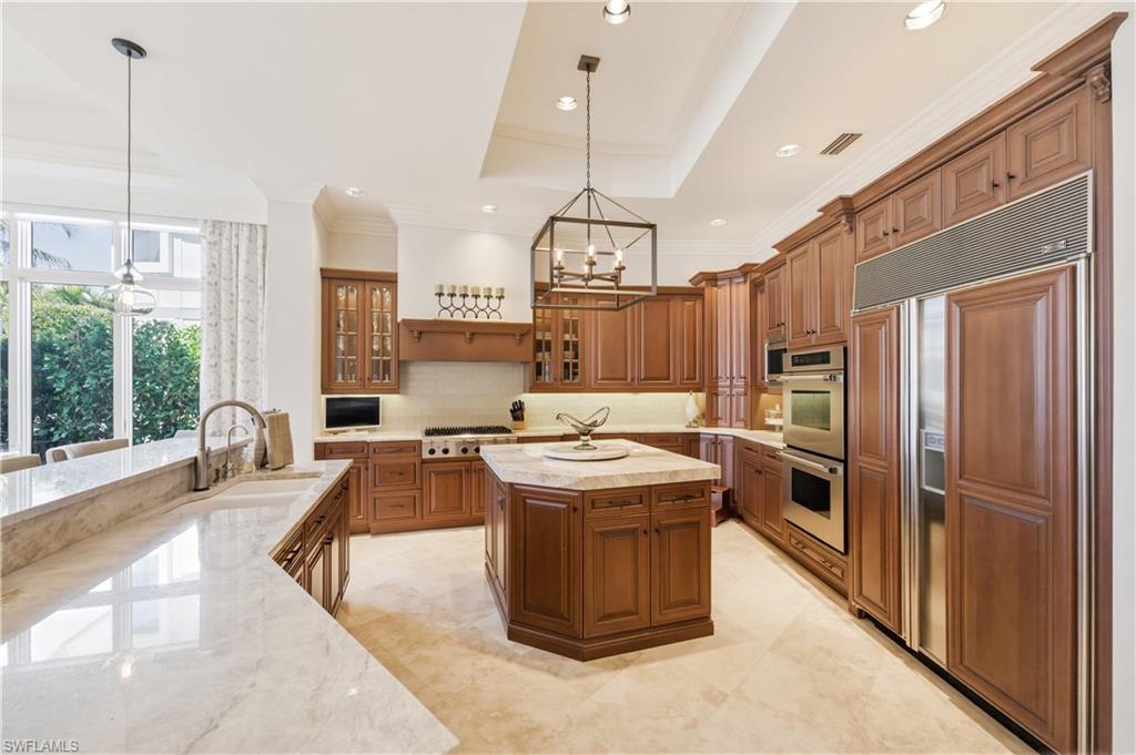 361 Pirates Bight Naples, FL 34103 - Photo 11 of 45 a kitchen with stainless steel appliances granite countertop a sink a stove and a refrigerator