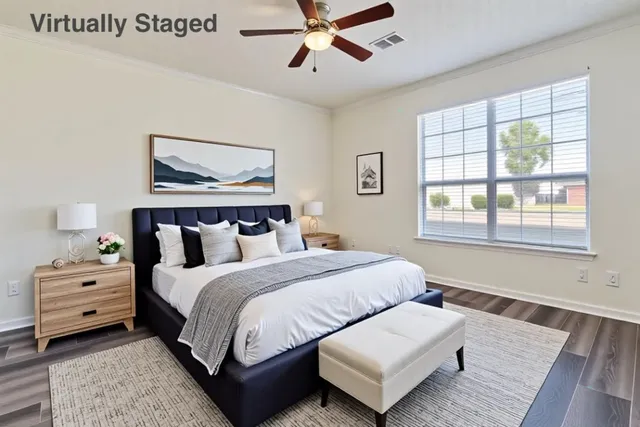 a bedroom with a bed and wooden floor