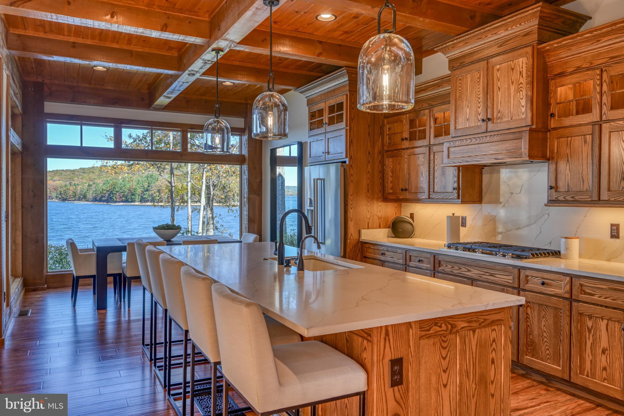 3135 Turkey Neck Road Swanton, MD 21561 - Photo 16 of 74 a kitchen with a table chairs and wooden floors