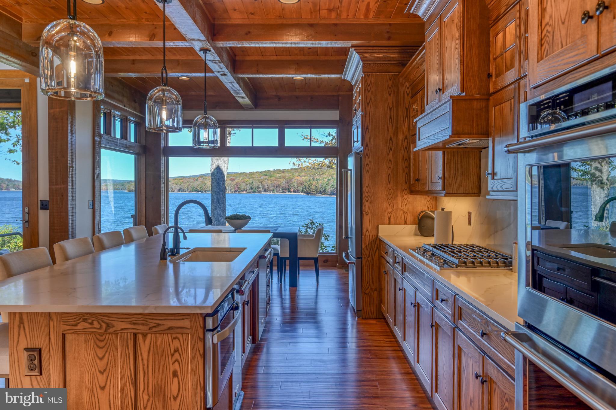 3135 Turkey Neck Road Swanton, MD 21561 - Photo 17 of 74 a kitchen with stainless steel appliances granite countertop a kitchen island a stove a table and chairs