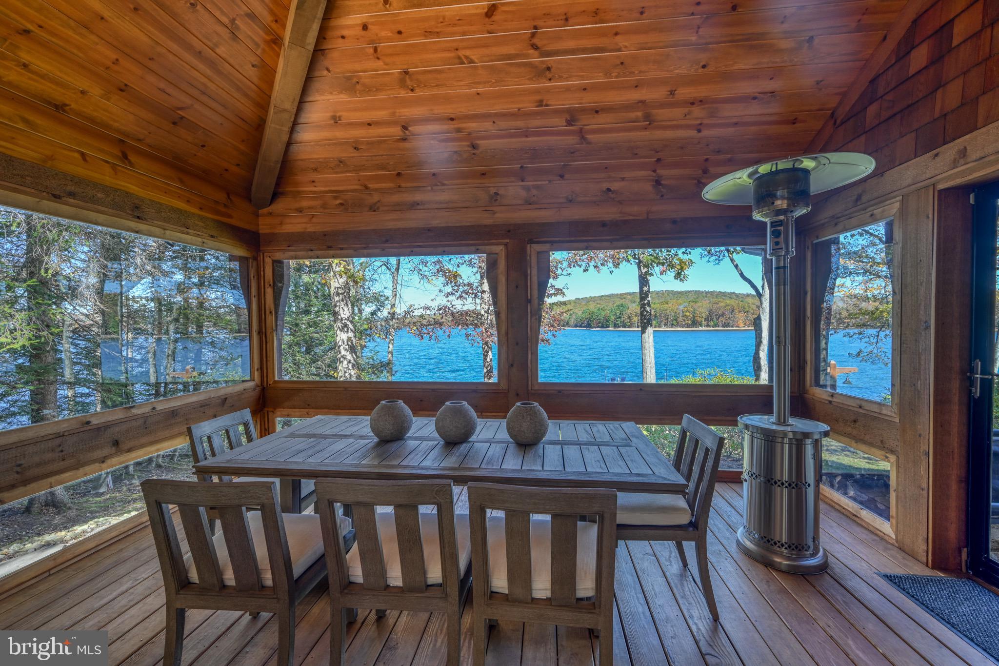 3135 Turkey Neck Road Swanton, MD 21561 - Photo 29 of 74 a view of a patio with a table chairs and wooden floor