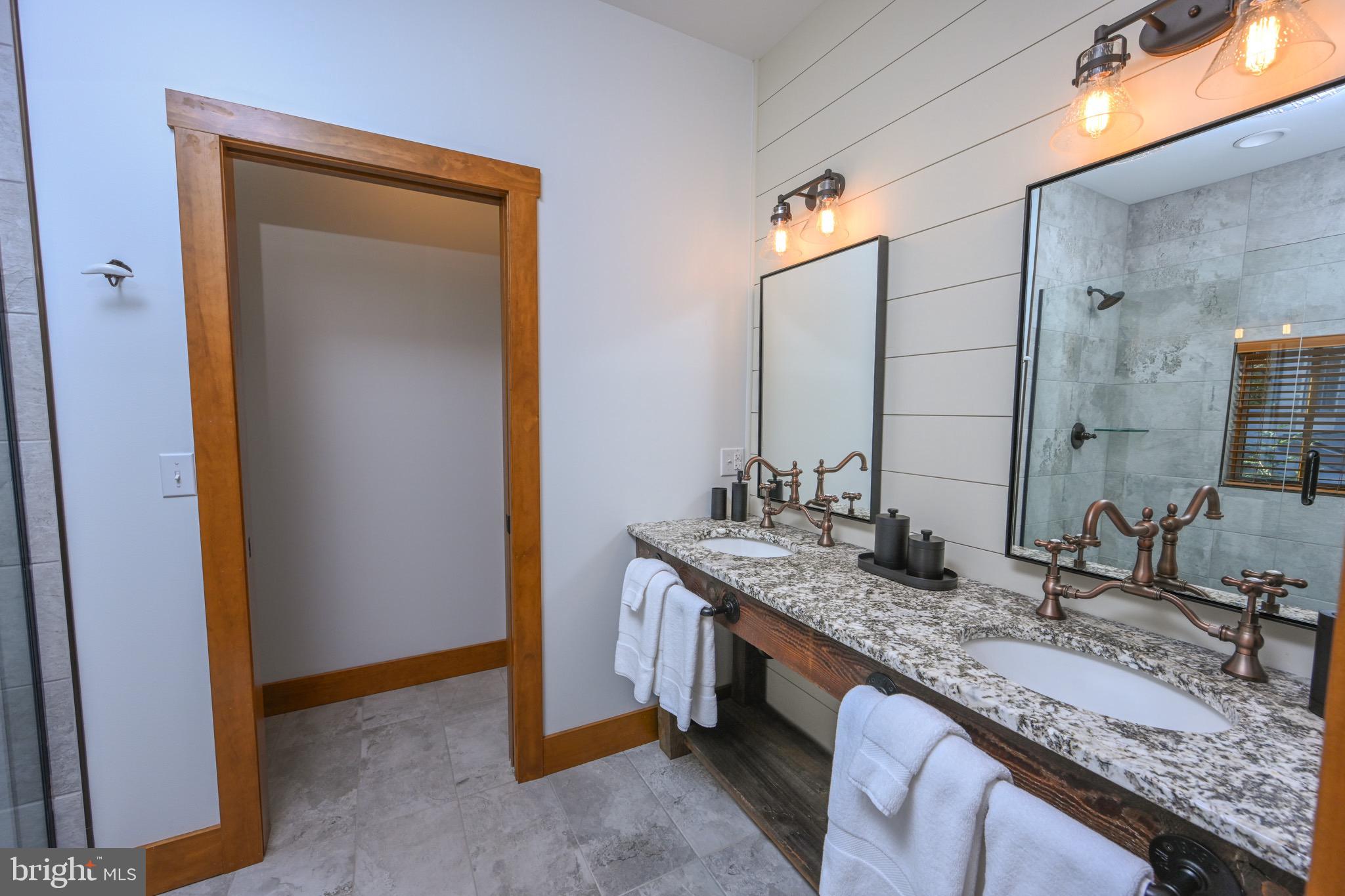 3135 Turkey Neck Road Swanton, MD 21561 - Photo 39 of 74 a bathroom with a granite countertop sink and a mirror