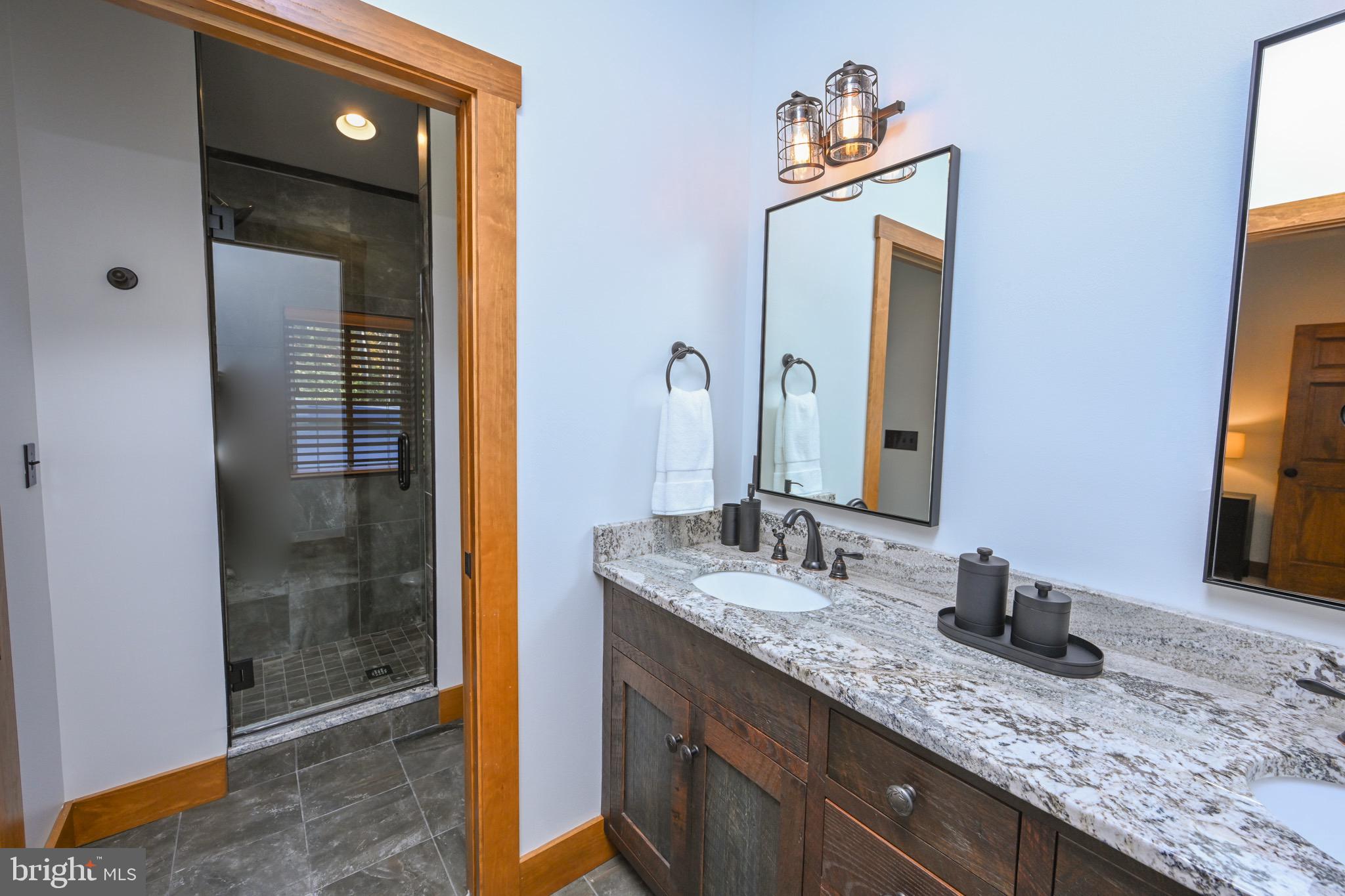 3135 Turkey Neck Road Swanton, MD 21561 - Photo 47 of 74 a bathroom with a granite countertop sink and a mirror
