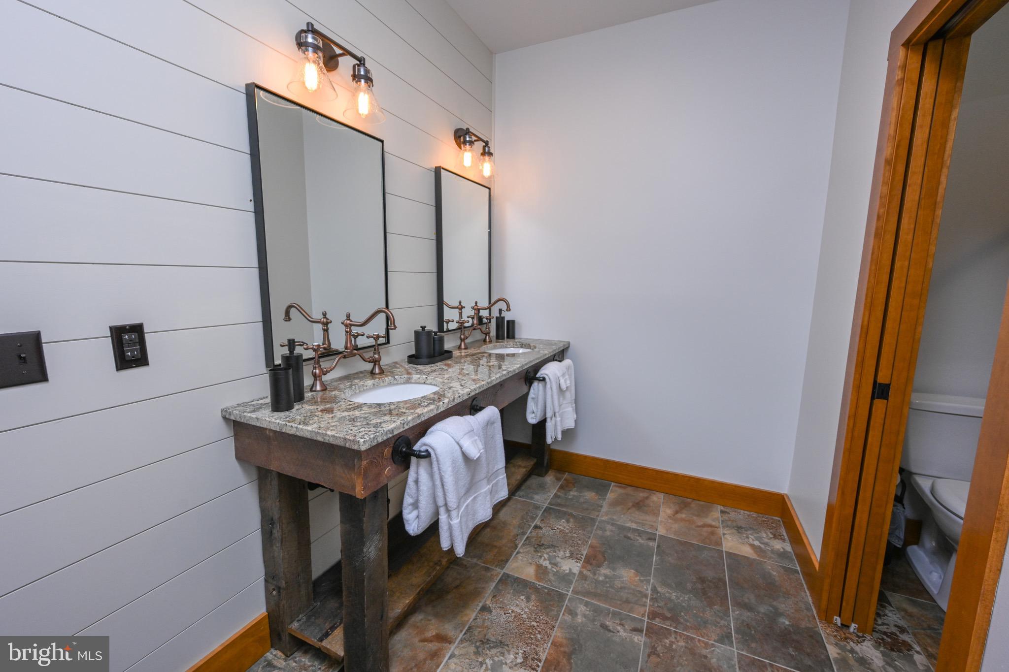 3135 Turkey Neck Road Swanton, MD 21561 - Photo 56 of 74 a bathroom with a granite countertop sink and a mirror