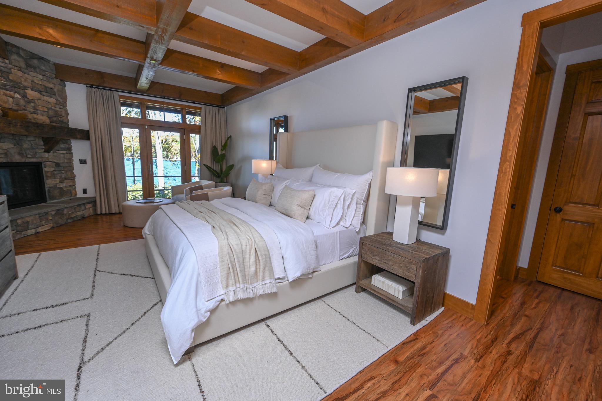 3135 Turkey Neck Road Swanton, MD 21561 - Photo 60 of 74 a spacious bedroom with a bed and a wooden floor